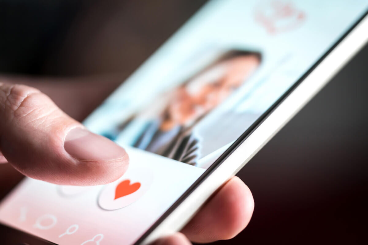 Online dating app or site in mobile phone screen. Man swiping and liking profiles on relationship site or application. Single guy using smartphone to find love, partner and girlfriend. Mockup website.