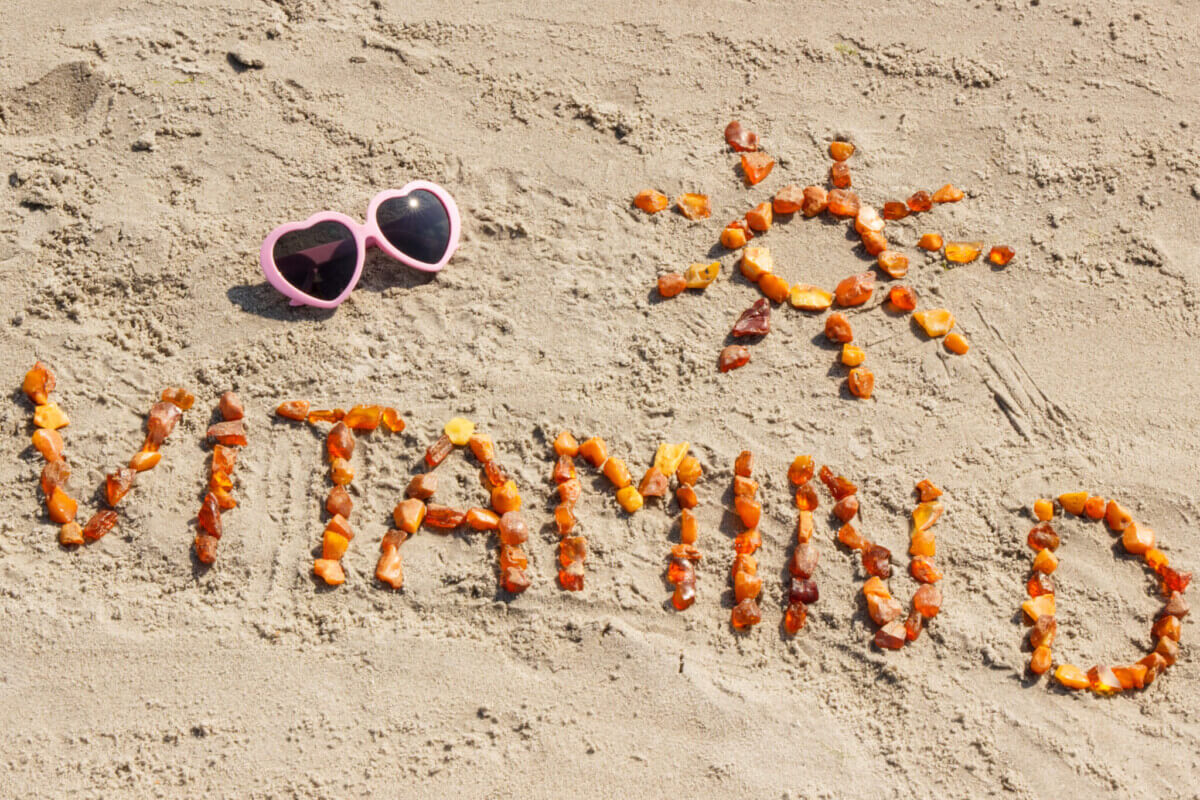 Sunglasses, inscription vitamin D and shape of sun at beach