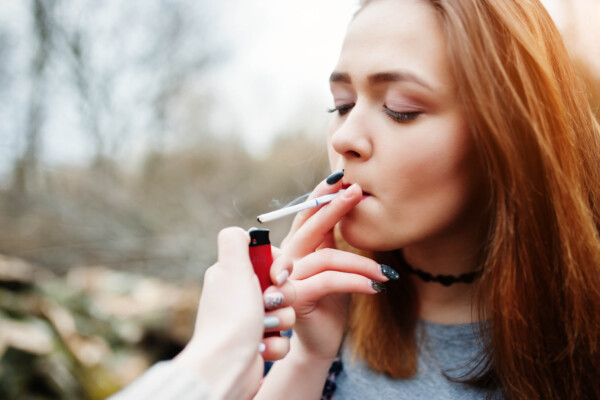 Teen girl smoking cigarette