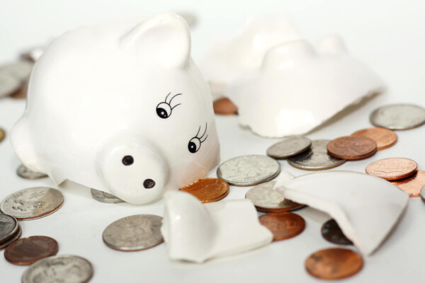 Raided retirement account: Broken piggy bank surrounded by money