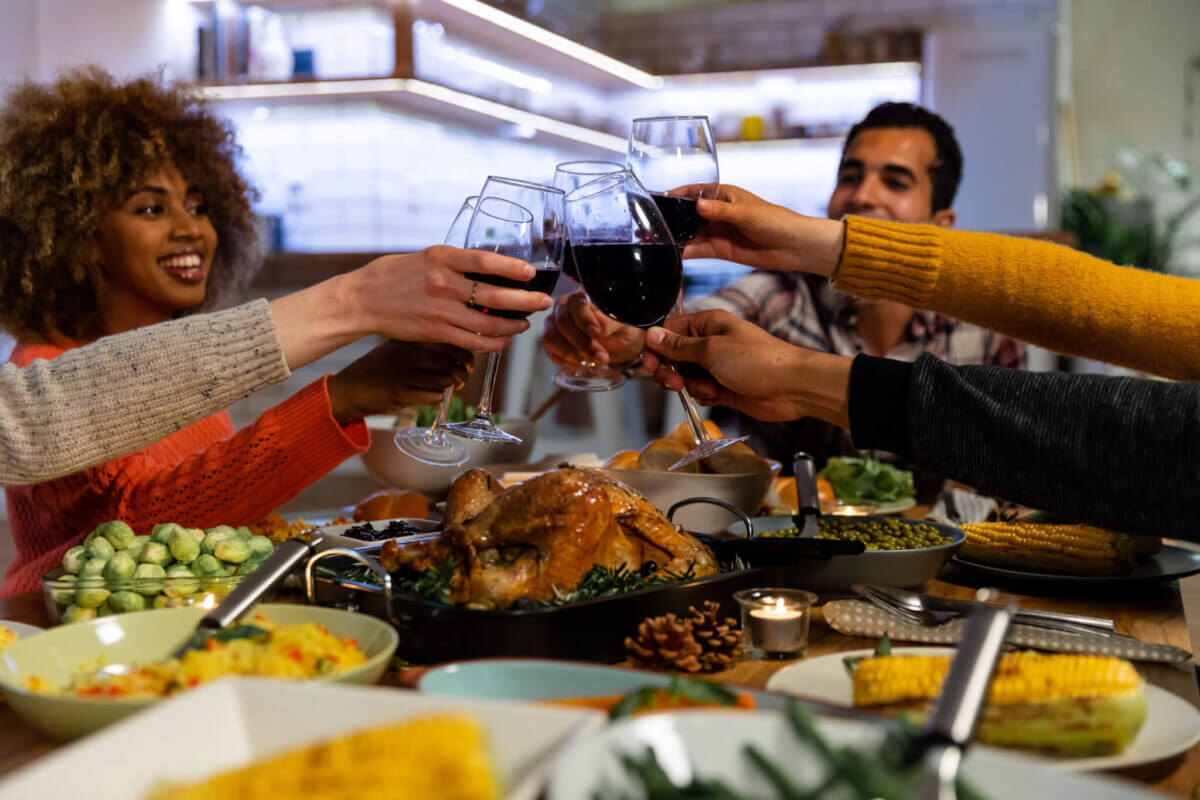Millennial adult friends celebrating Thanksgiving together at home
