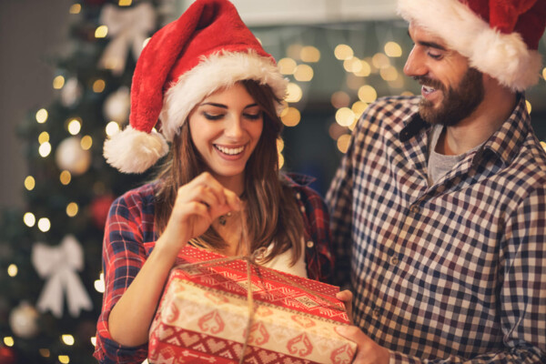 Man and woman opening Christmas gifts