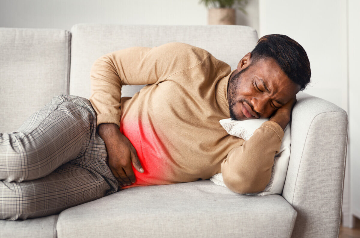 Guy Touching Stomach Red Pain Zone Lying On Sofa