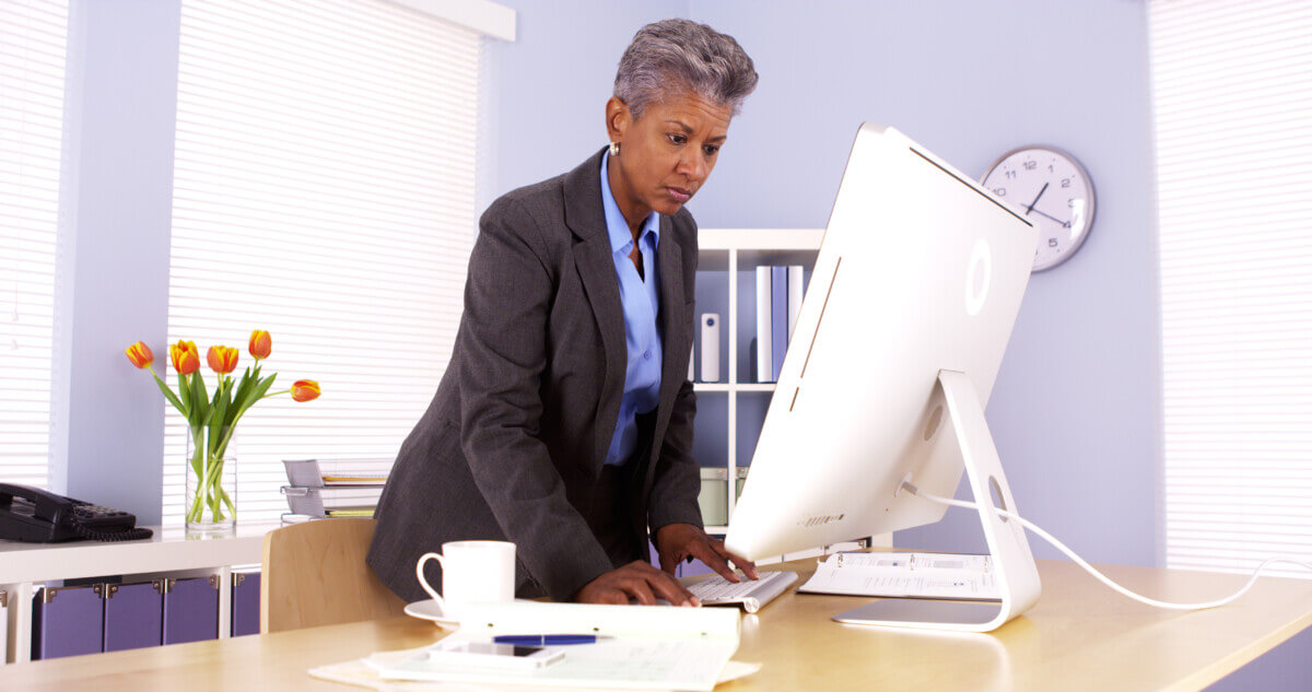 Senior African businesswoman working at desk