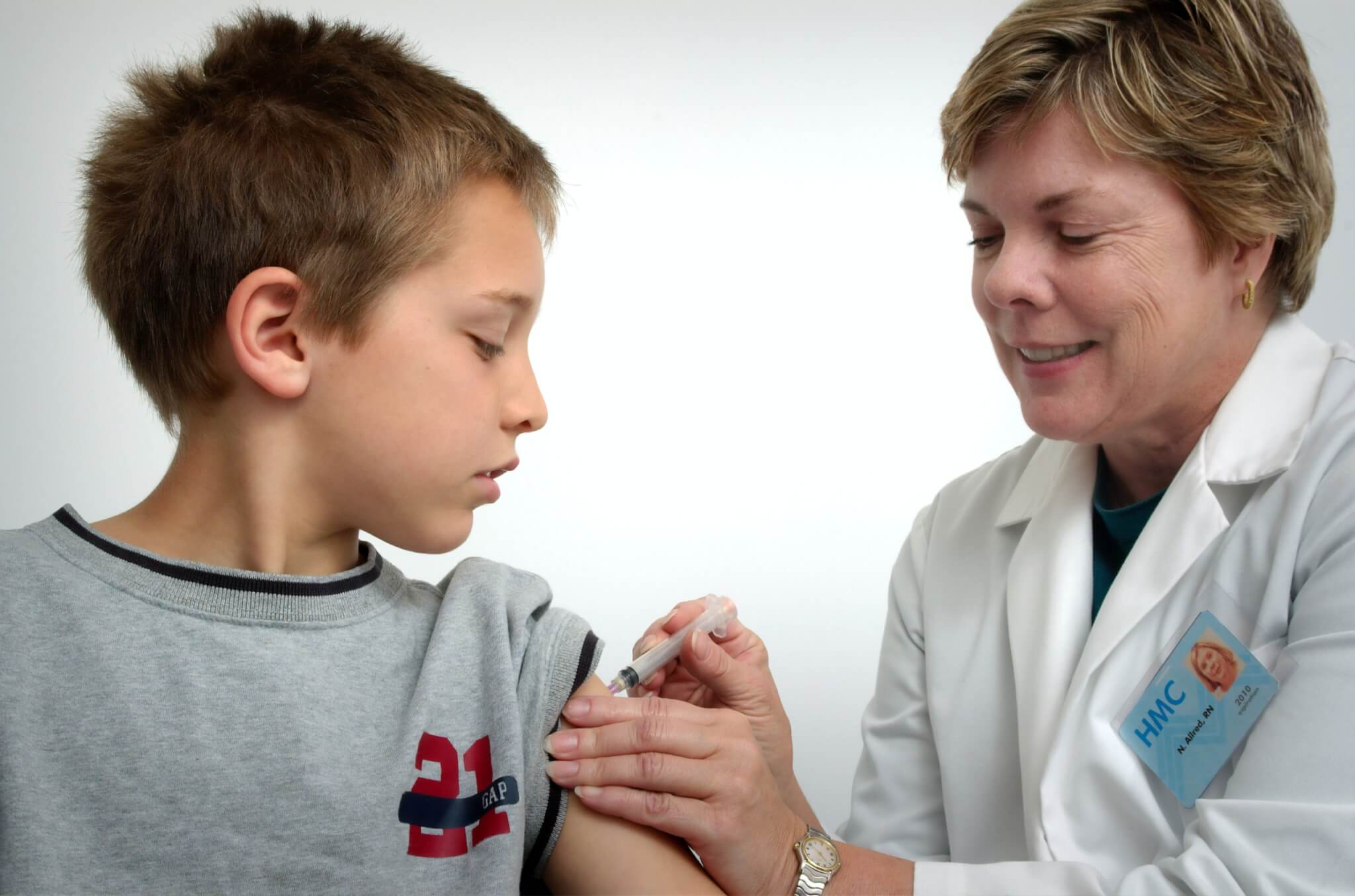 Child receiving vaccination at doctor's office