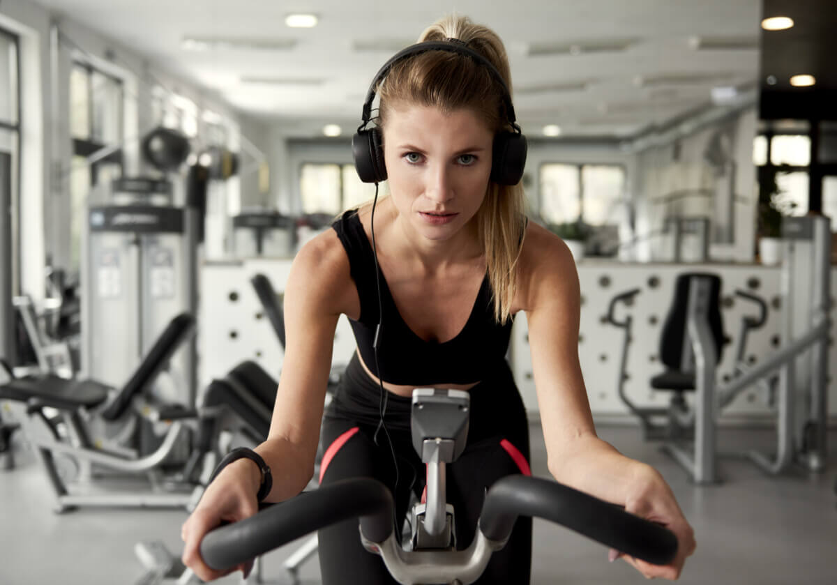 Sporty woman working out with exercise bike
