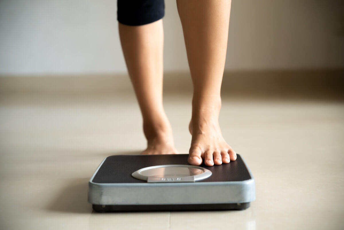 Woman checking weight on scale