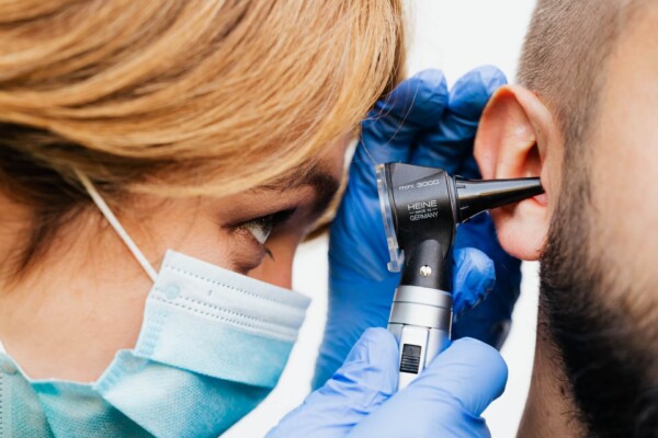 Doctor looking into human ear