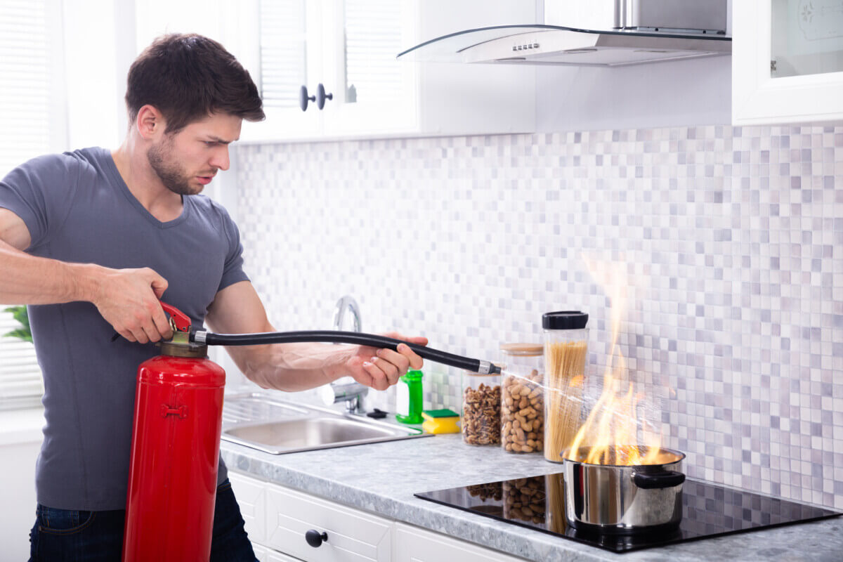 Man Extinguishing Burning Cooking Pot
