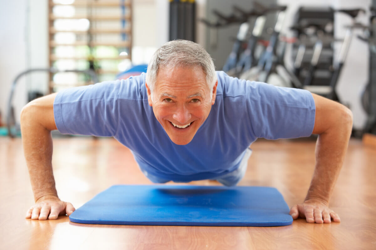 Older Man Doing Push Ups In Gym