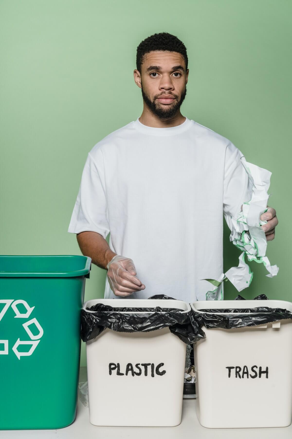 Person sorting trash in recycling bins