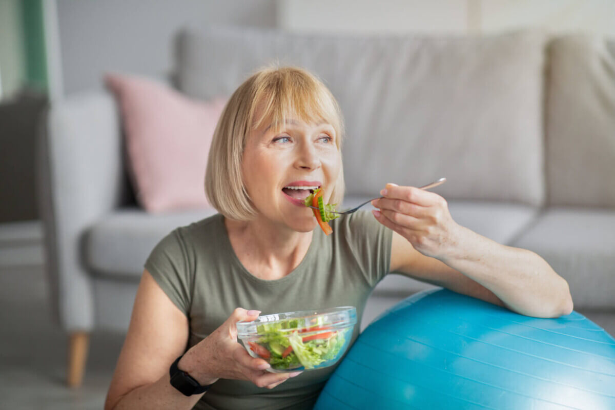 Woman eating salad, vegetarian or plant-based diet and healthy lifestyle concept