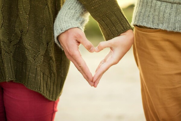Couple making heart with their hands