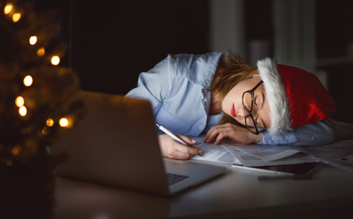 Woman tired from working late at night during holidays