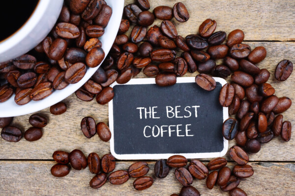 "The Best Coffee" written on a chalkboard in front of coffee beans