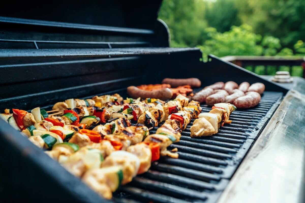 Barbecue chicken, hot dogs and burgers on the grill.
