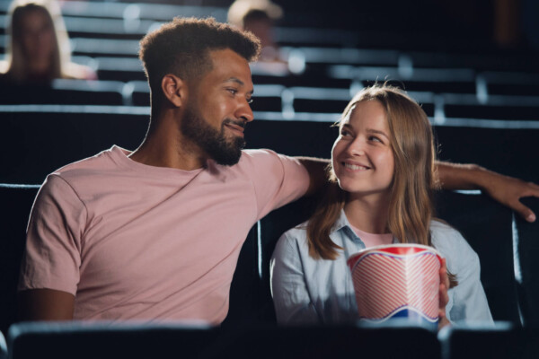 Couple watching a romantic comedy in the movie theater