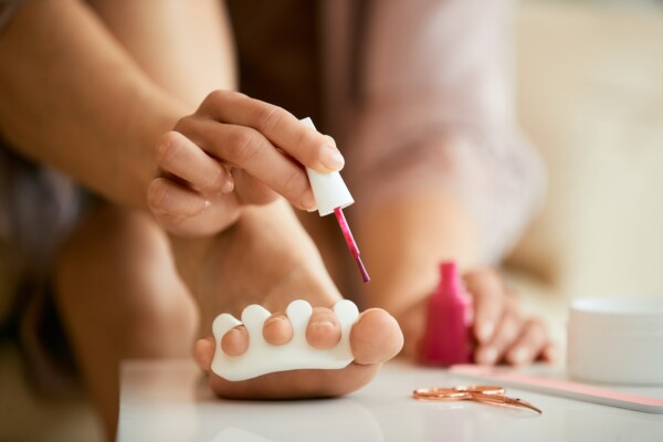 Woman giving herself a pedicure