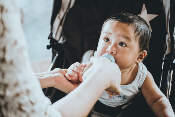 Baby drinking formula or milk from a bottle