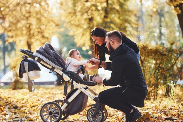 Couple with baby in stroller outside