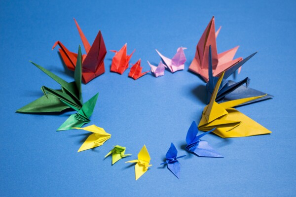 Paper origami cranes shaped into a heart