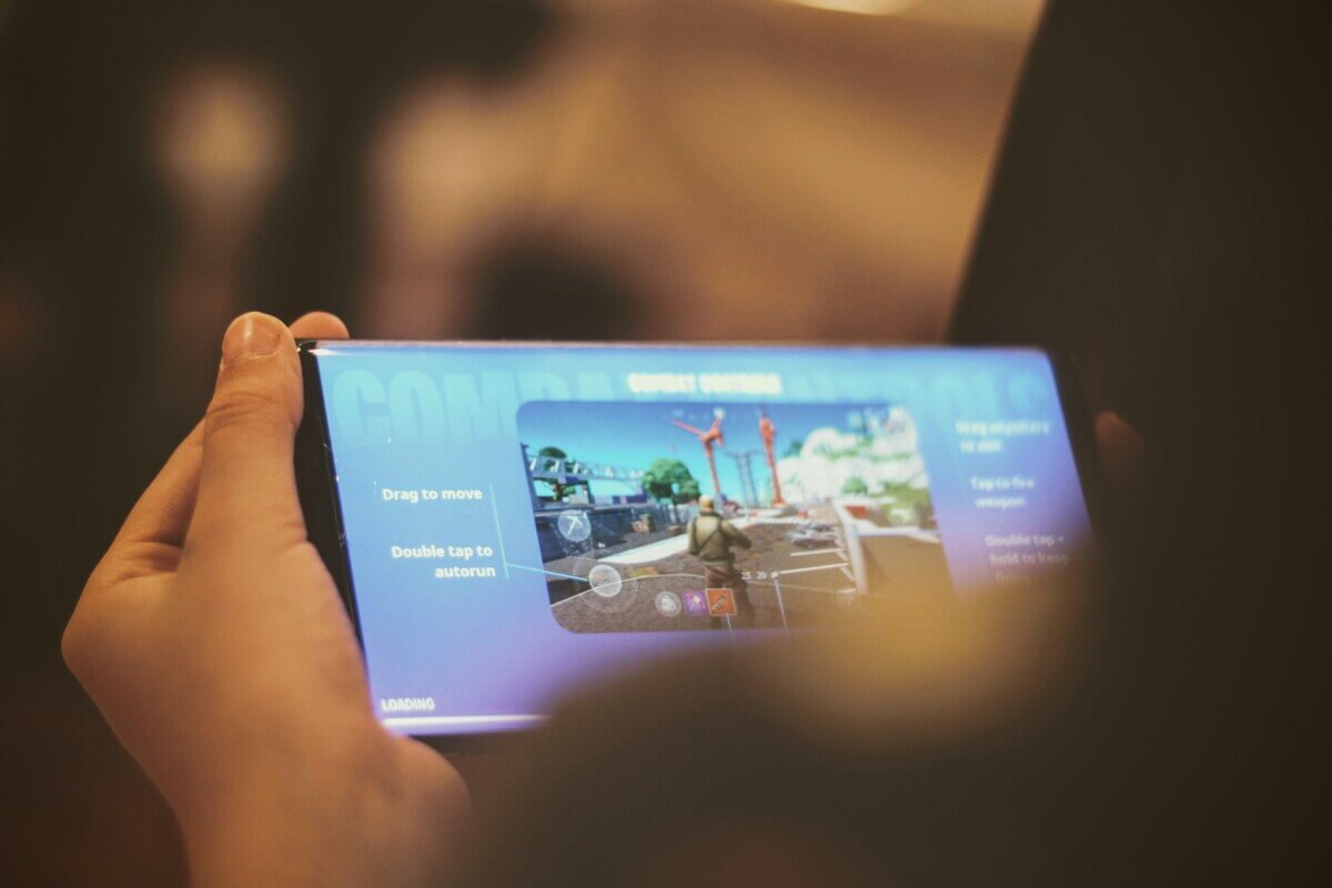 Person playing Fortnite on a smartphone
