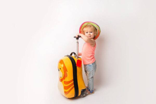 Young child holding luggage