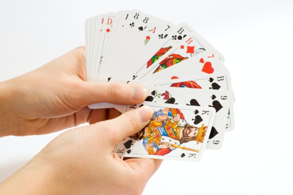 A person holding playing cards