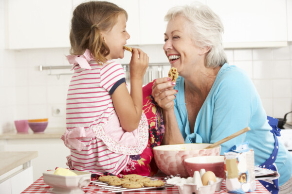 Grandmother and grandchild baking chocolate chip cookies