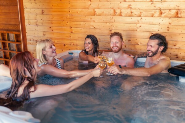 Group of friends toasting in a hot tub jacuzzi