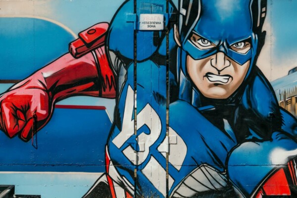 red white and blue graffiti of Captain American painted on a wall
