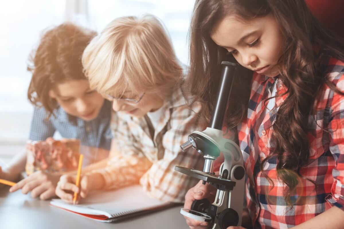 Children doing a science or STEM project with microscope
