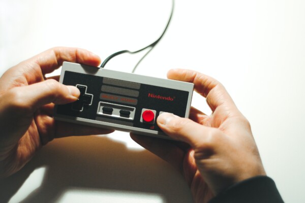 Person playing Nintendo using a NES controller