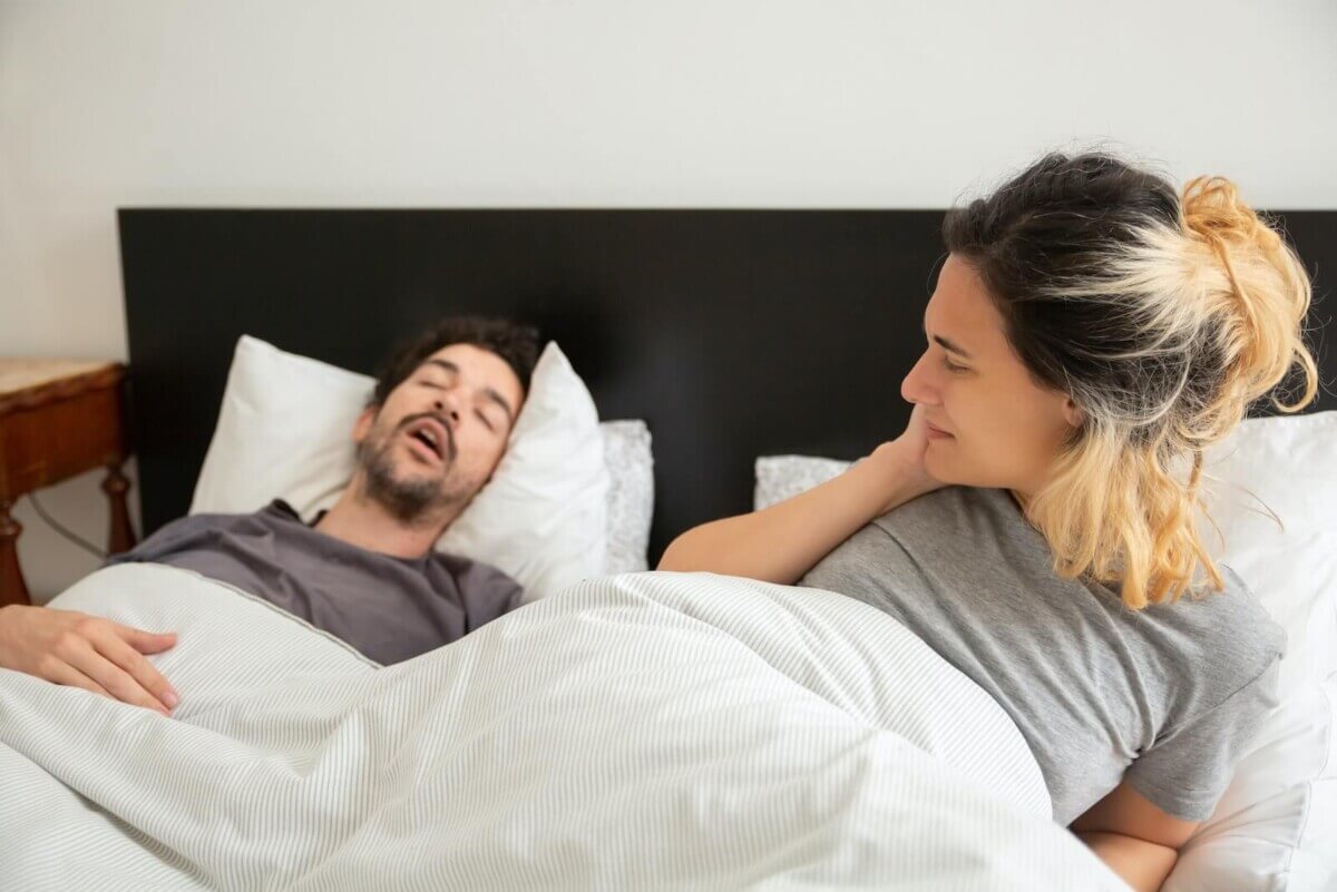 Woman staring at man snoring