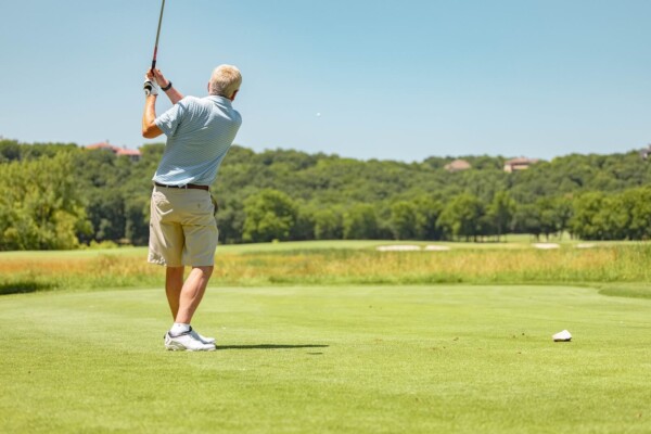 older adult playing golf