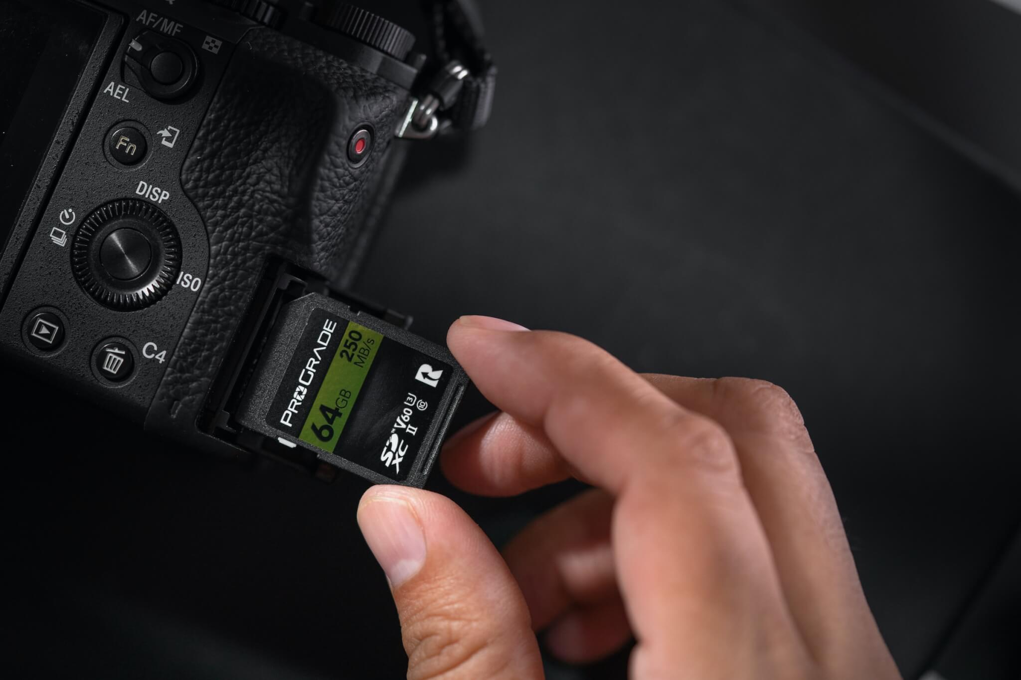 Hand pulling SD card out of camera