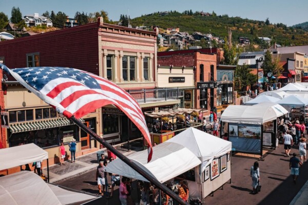 An American flag flying above a market on Main Street in PArk City, Utah