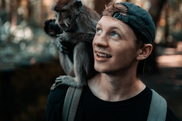 monkey sitting on man's shoulder
