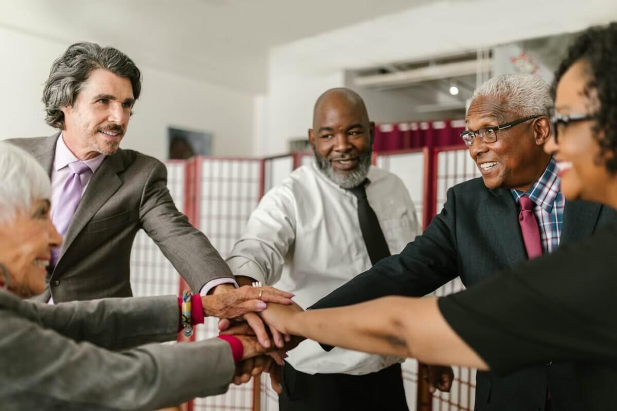 Older adults joining hands