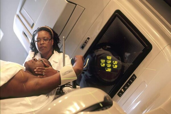 Female cancer patient getting ready for radiation therapy.