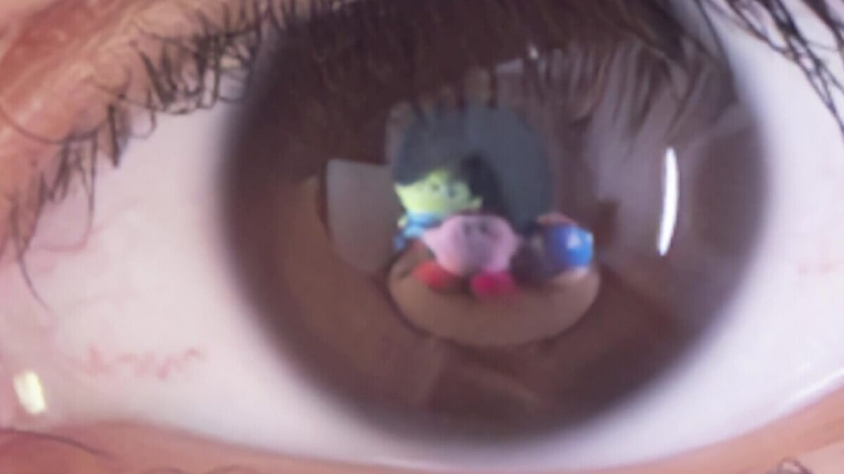 Alien toys seen in eye reflection