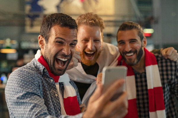 Men streaming a football game on phone