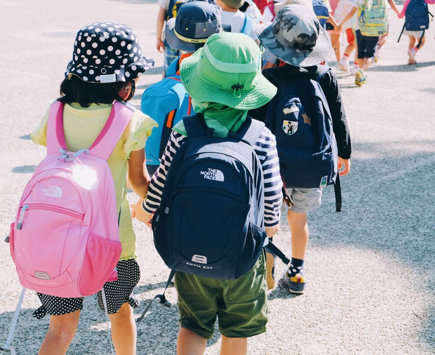 Kids walking to school wearing backpacks