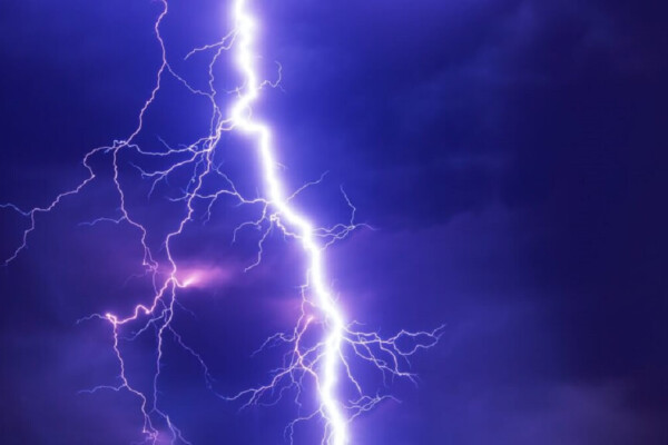 pic of a lightning bolts flashing through a dark blue sky