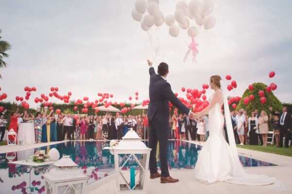 man and woman wedding holding balloons