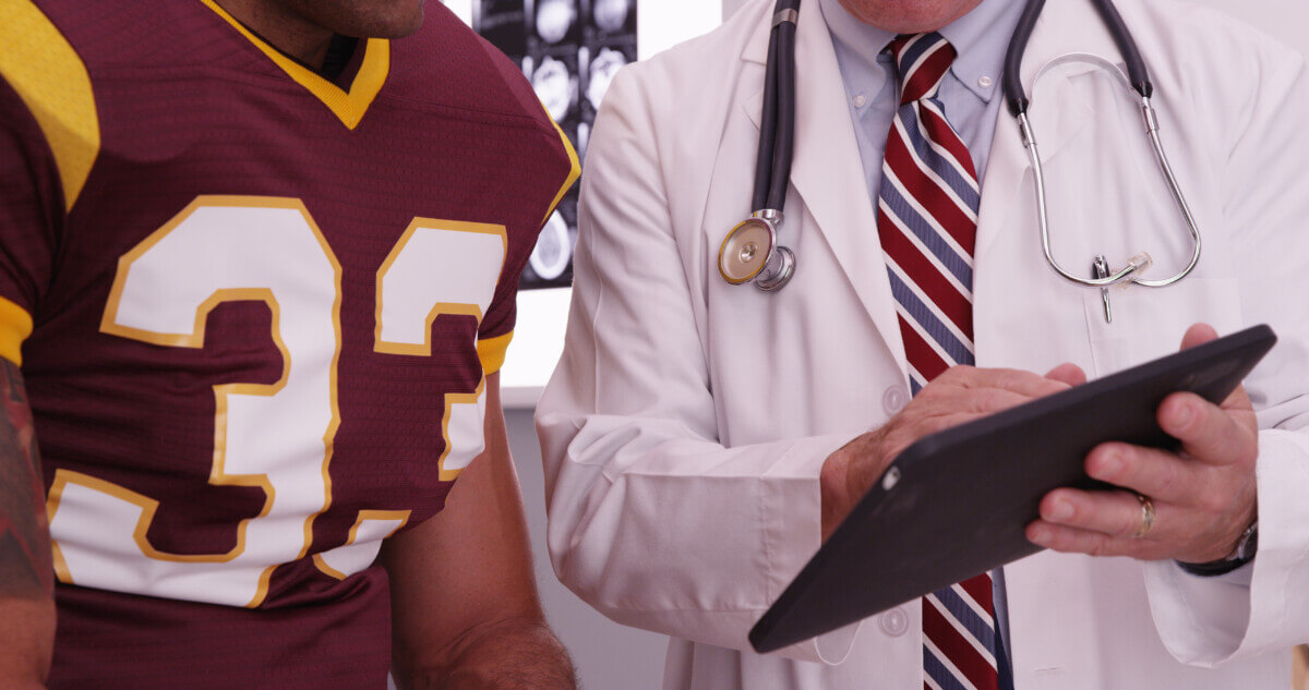 Football player talking to a doctor