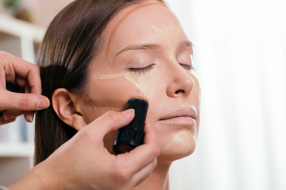 A makeup artist using a contour stick