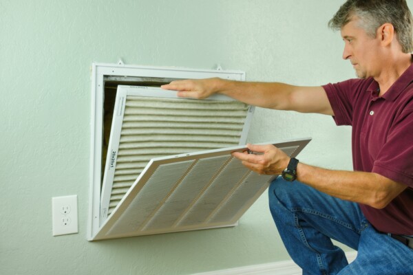 Man replacing home ventilation air filter