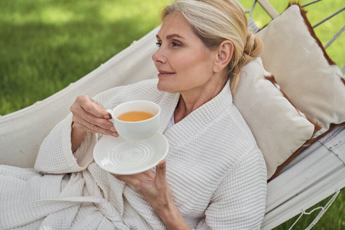 Woman drinking tea on hammock