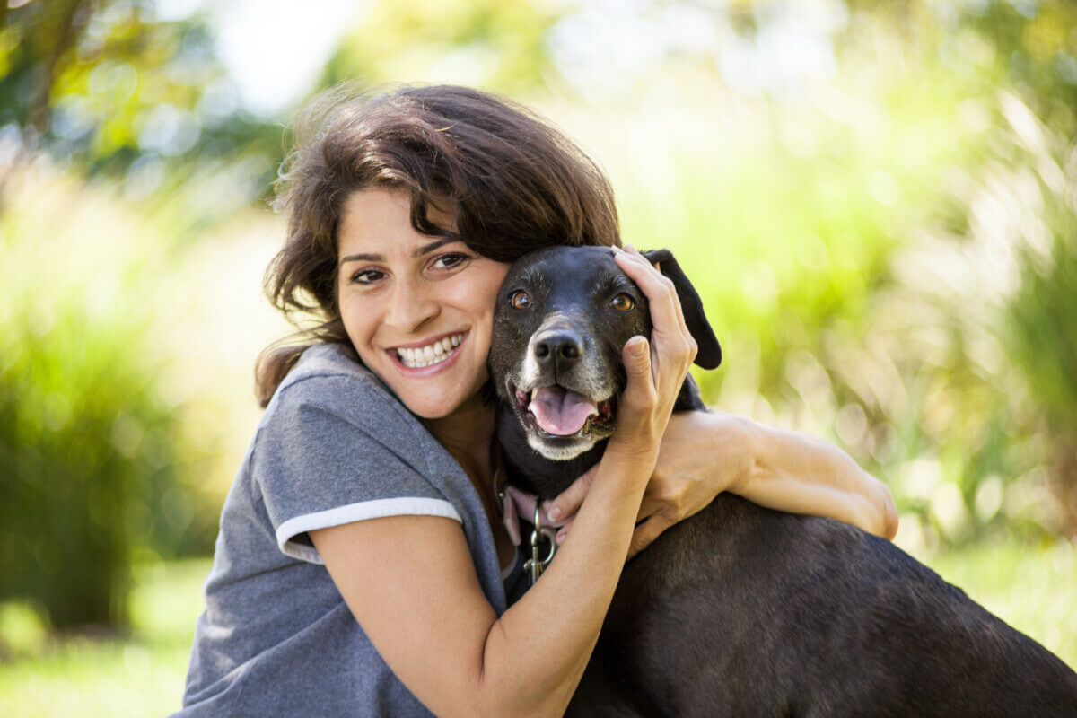 A woman hugging her dog